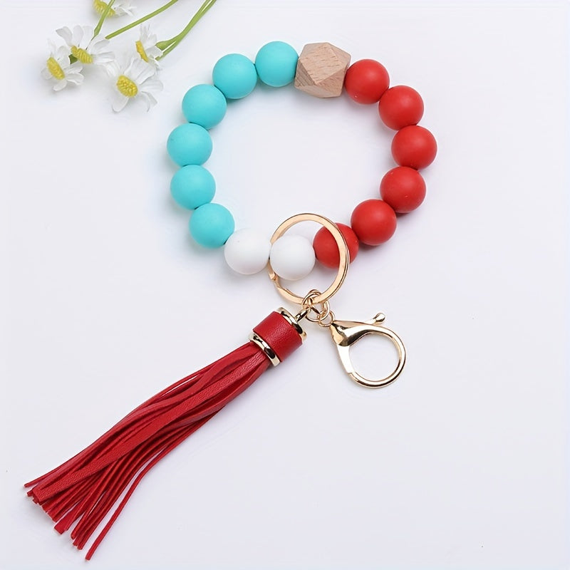 Colorful beaded keychain with a red tassel on a white background